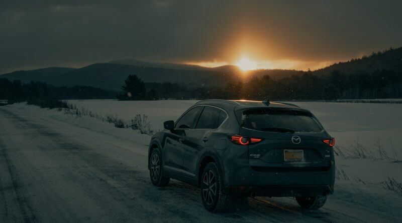 black bmw x 6 on snow covered field during daytime